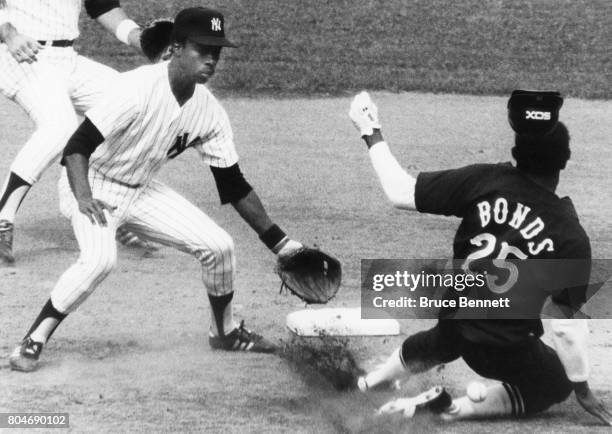 Bobby Bonds of the Chicago White Sox steals second base as Willie Randolph of the New York Yankees can't handle the throw from catcher Thurman Munson...