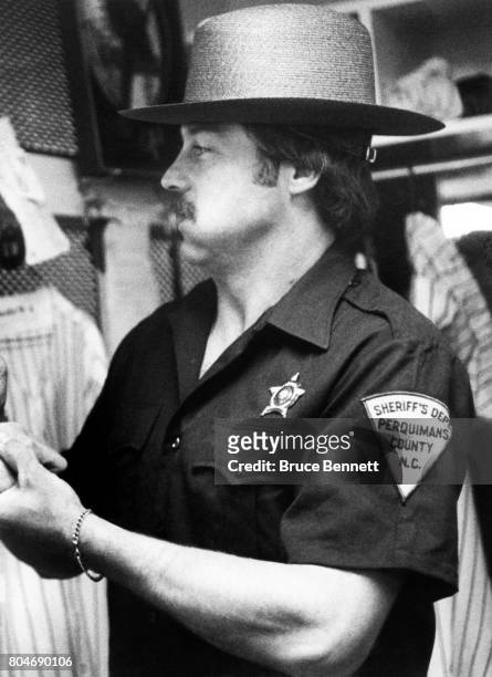 Pitcher Jim "Catfish" Hunter of the New York Yankees comes dressed in a Sheriff's Department uniform from Perquiman's County, North Carolina in which...