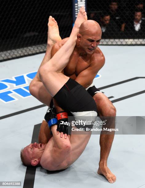 Dennis Siver of Germany attempts to submit BJ Penn in their featherweight bout during the UFC Fight Night event at the Chesapeake Energy Arena on...