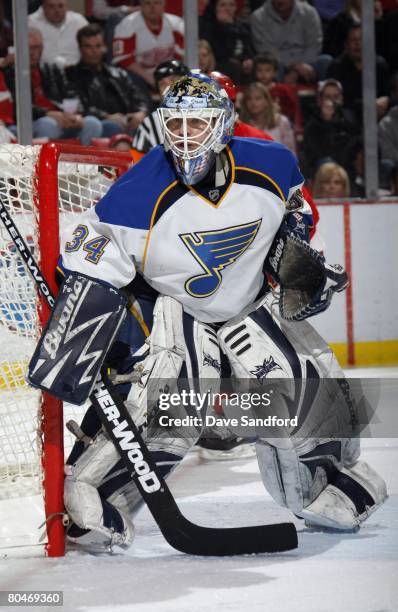 Goaltender Manny Legace of the St. Louis Blues keeps an eye on the puck during the NHL game against the Detroit Red Wings at Joe Louis Arena March...