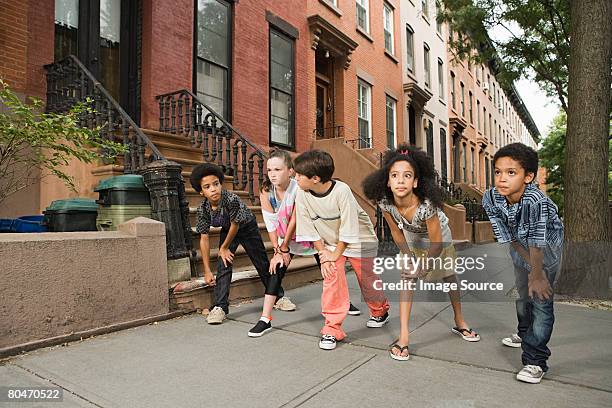 kids about to race on sidewalk - kids fashion stockfoto's en -beelden