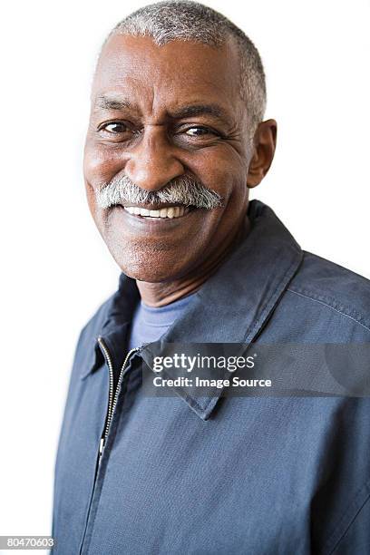 smiling senior man with a mustache - old person on white background stockfoto's en -beelden