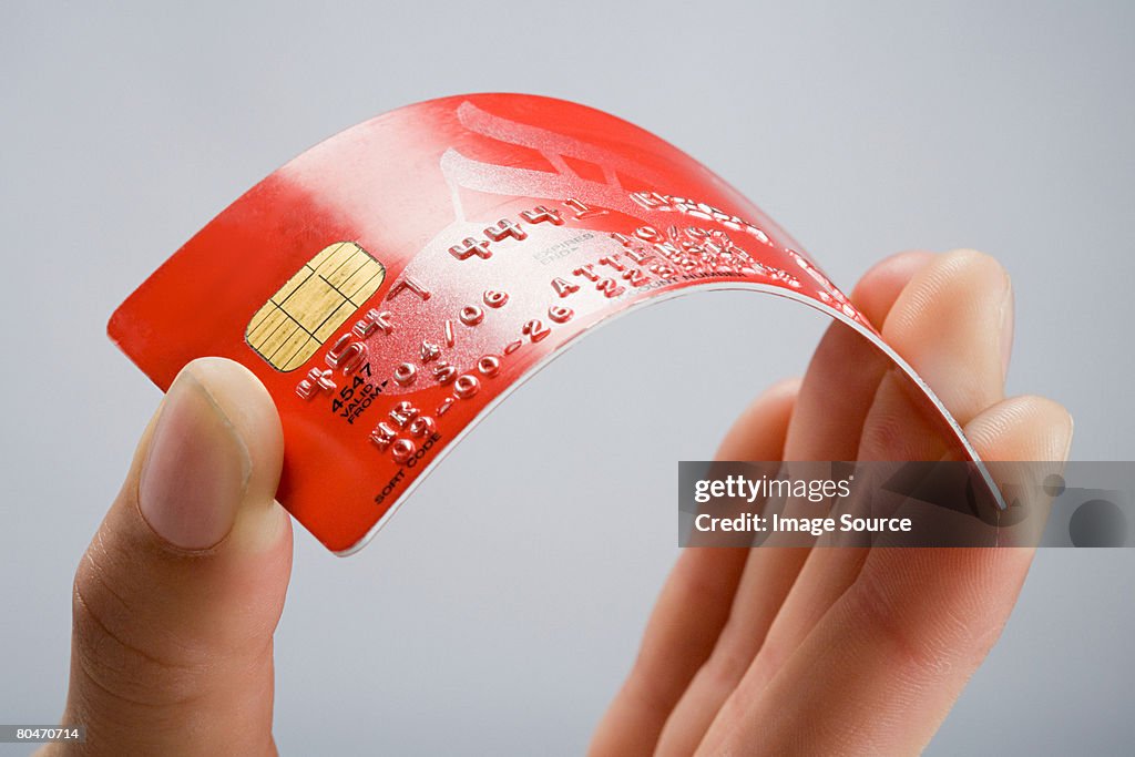 A person holding a credit card