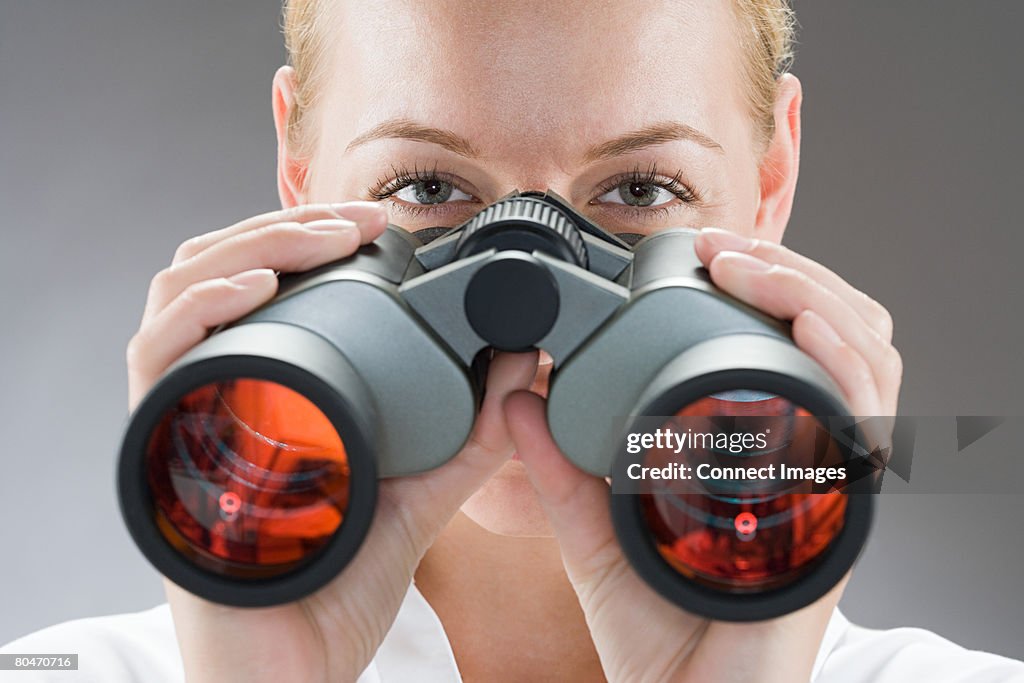 A woman looking through binoculars