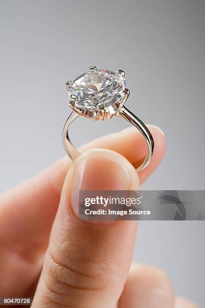 a woman holding an engagement ring - ring stock pictures, royalty-free photos & images