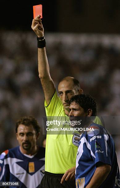 Luis Palacios , of San Jose, receives a red card after tackling Kleber , of Santos FC, during their Libertadores Cup football match held at Vila...