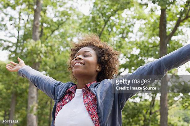 happy woman in forest - scena non urbana foto e immagini stock