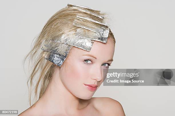 a woman having her hair highlighted - tin foil hat stock-fotos und bilder