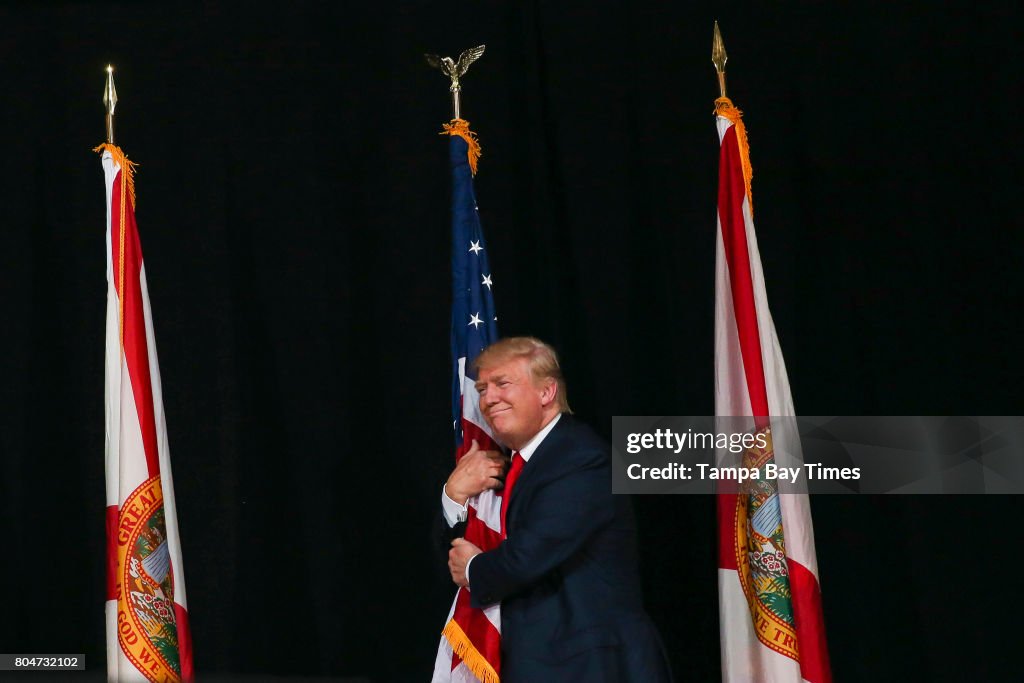 Hugging Flag Donald Trump hugs the American Flag as he takes the stage during the ...