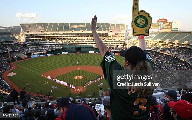 An Oakland A's fan cheers before the start of the Opening Day game of the Oakland Athletics and The Boston Red Sox at the McAfee Coliseum April 1,...