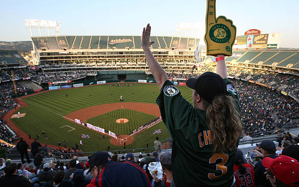 An Oakland A's fan cheers before the start of the Opening Day game of the Oakland Athletics and The Boston Red Sox at the McAfee Coliseum April 1,...