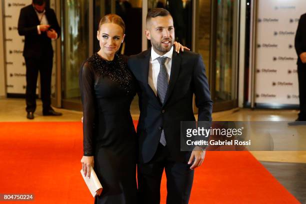 Spanish soccer player Jordi Alba and his girlfriend Romarey Ventura pose for pictures on the red carpet during Lionel Messi and Antonela Rocuzzo's...
