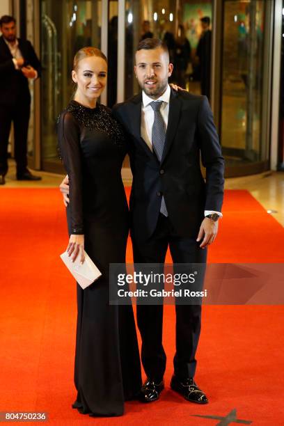 Spanish soccer player Jordi Alba and his girlfriend Romarey Ventura pose for pictures on the red carpet during Lionel Messi and Antonela Rocuzzo's...