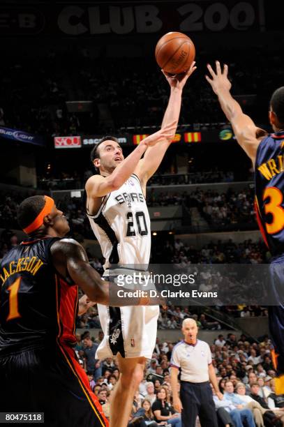 Manu Ginobili of the San Antonio Spurs shoots against Brandan Wright and Stephen Jackson of the Golden State Warriors on April 1, 2008 at the AT&T...