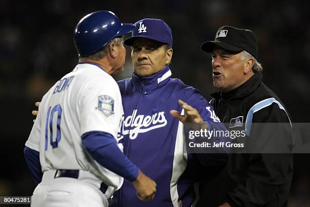 Los Angeles Dodgers manager Joe Torre attempts to break up an arguement between third base umpire Ed Montague and third base coach Larry Bowa in the...