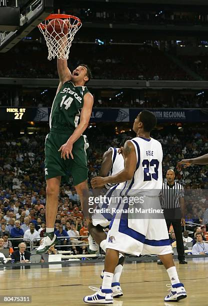 Goran Suton of the Michigan St. Spartans slam dunks the ball over Derrick Rose of the Memphis Tigers during the third round game of the South...