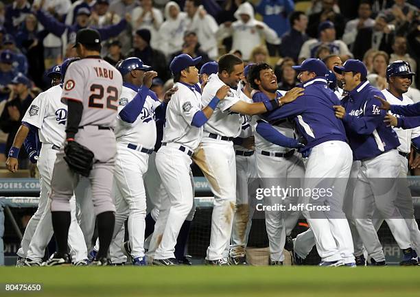 Delwyn Young of the Los Angeles Dodgers is congratulated by his teammates after hitting the game winning RBI in the ninth inning as Keiichi Yabu of...