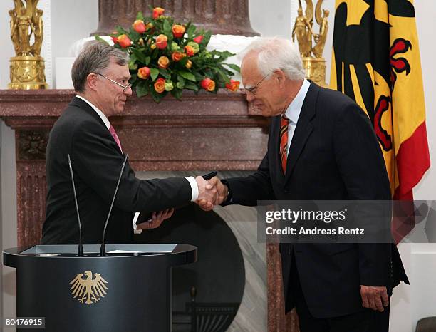 German President Horst Koehler hands out the documents of dismissal to Wolfgang Hoffmann-Riem , Federal Constitutional Court judge at Bellevue Castle...