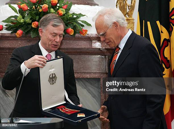 Wolfgang Hoffmann-Riem , Federal Constitutional Court judge receives the Federal Cross Of Merit from German President Horst Koehler after Koehler...