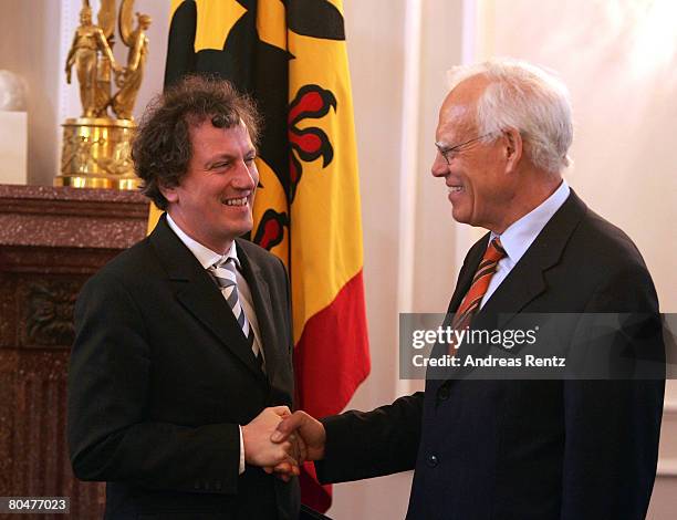 Outgoing Wolfgang Hoffmann-Riem , Federal Constitutional Court judge shakes hands with his follower Johannes Masing during an official handing over...