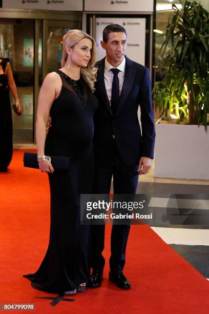 Argentine soccer player Angel Di María and his wife Jorgelina Cardoso pose for pictures on the red carpet during Lionel Messi and Antonela Rocuzzo's...