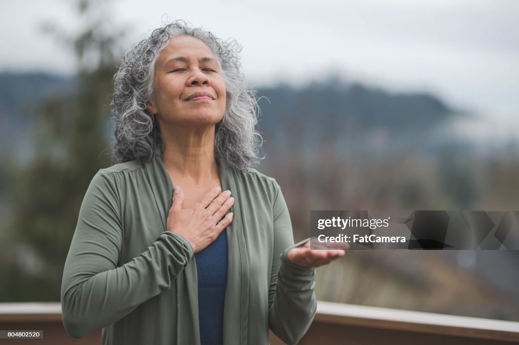 Hawaiian woman doing yoga pose outside