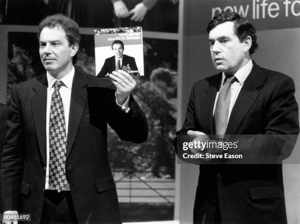 Tony Blair, leader of the Labour party holds up his new manifesto, July 1996. With him is Gordon Brown, shadow Chancellor of the Exchequer.