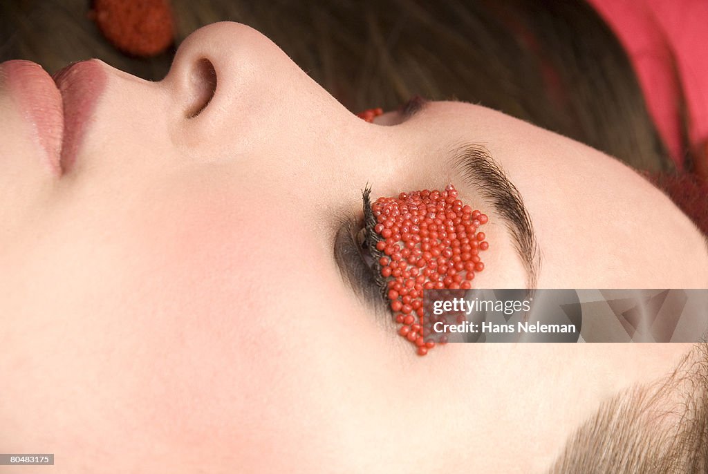 Woman with sprinkles over eyelid, close-up