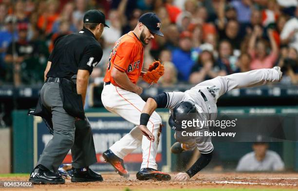 Lance McCullers Jr. #43 of the Houston Astros tags out Austin Romine of the New York Yankees as he atempts to score on a wild pitch in the fourth...