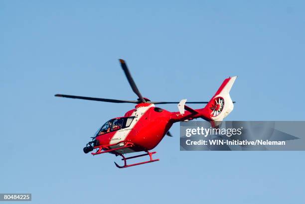 red rescue helicopter, low angle view - helicóptero fotografías e imágenes de stock