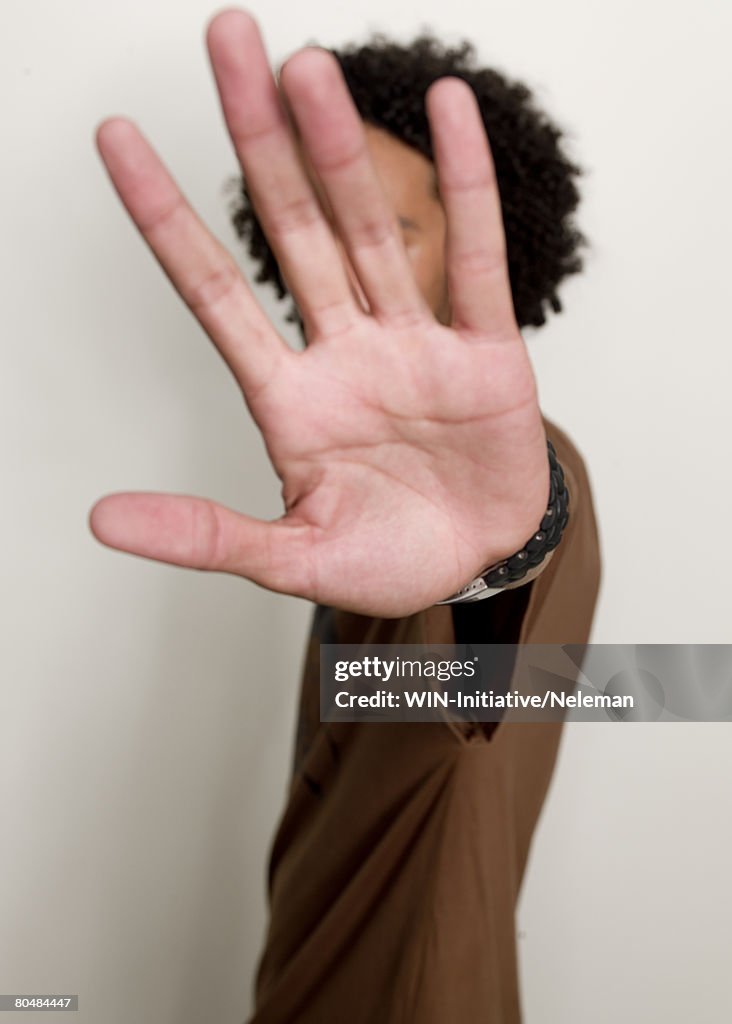 Young man showing palm