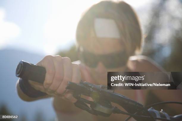 young woman riding mountain bike - handlebar stock pictures, royalty-free photos & images