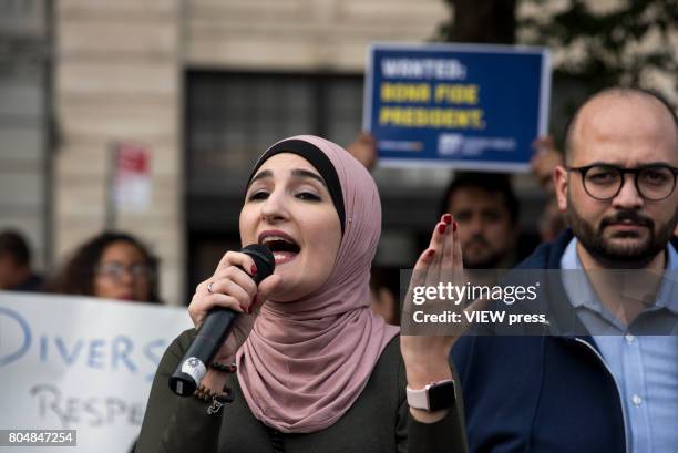 Immigrants join activists for an evening protest in Manhattan hours before a revised version of President Donald Trump's travel ban that was approved...