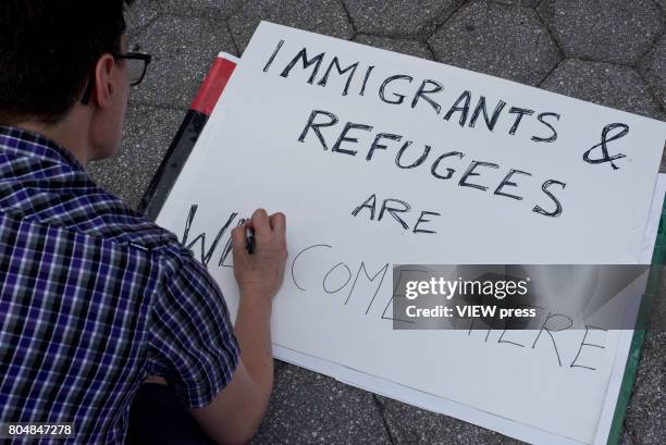 Immigrants join activists for an evening protest in Manhattan hours before a revised version of President Donald Trump's travel ban that was approved...