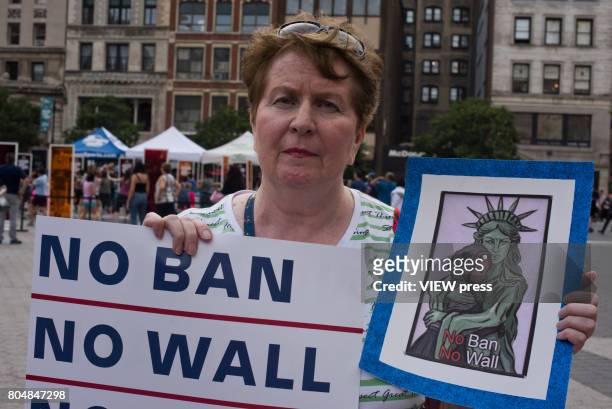 Immigrants join activists for an evening protest in Manhattan hours before a revised version of President Donald Trump's travel ban that was approved...