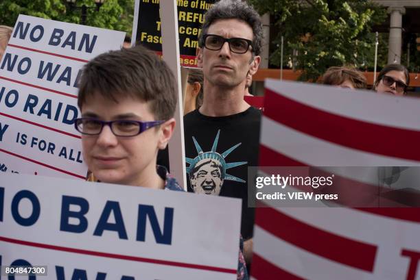 Immigrants join activists for an evening protest in Manhattan hours before a revised version of President Donald Trump's travel ban that was approved...