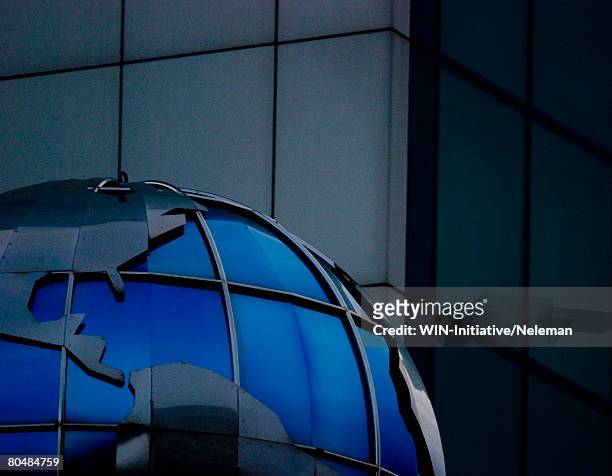 blue round globe by building, close-up - commonwealth of independent states stock-fotos und bilder