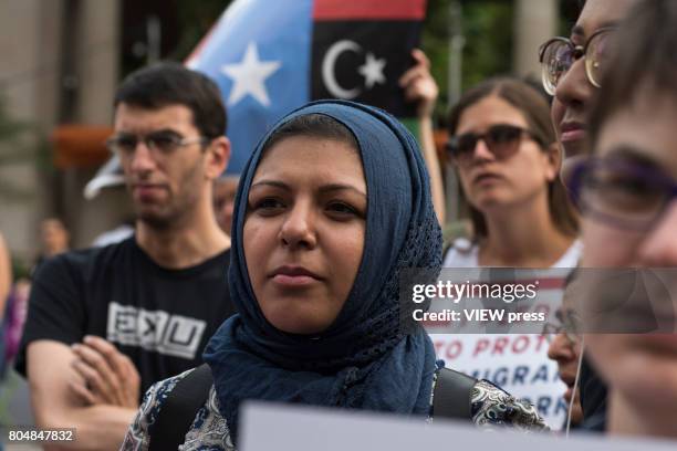 Immigrants join activists for an evening protest in Manhattan hours before a revised version of President Donald Trump's travel ban that was approved...