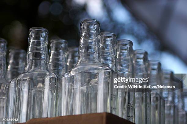 stack of empty vodka bottles - ウォッカ ストックフォトと画像