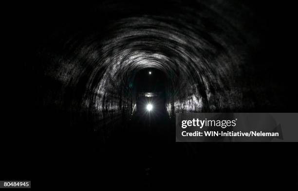 headlamp in an underground tunnel - cave stock pictures, royalty-free photos & images