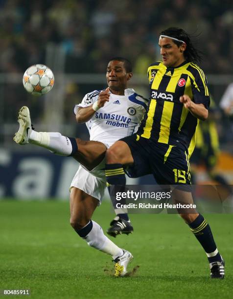 Onder Turaci of Fenerbahce and Florent Malouda of Chelsea battle for the ball during the UEFA Champions League Quarter Final 1st Leg match between...