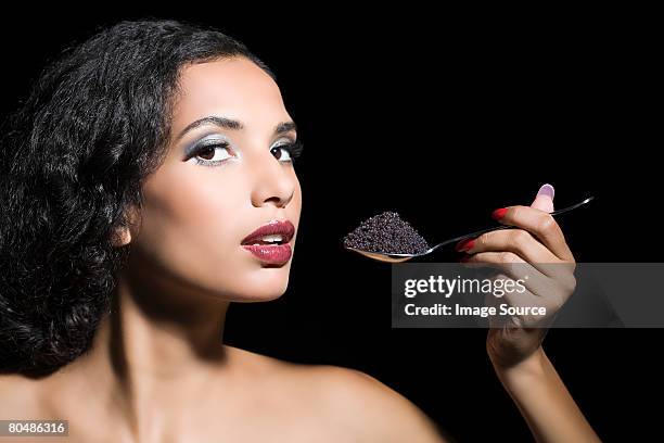 woman eating caviar - kaviaar stockfoto's en -beelden