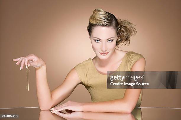 woman holding a gold key - smug bildbanksfoton och bilder