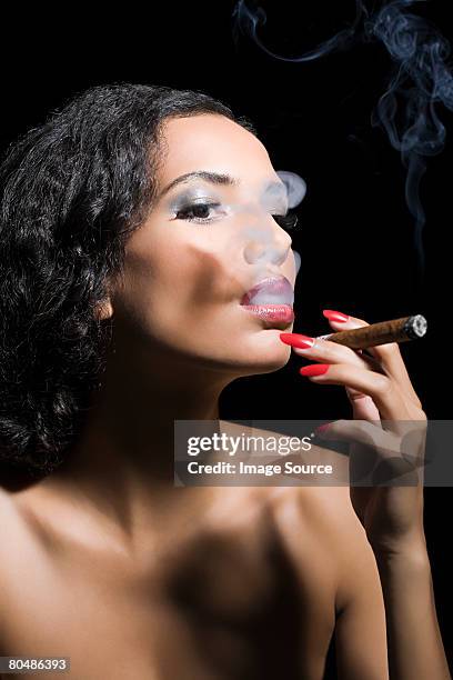 beautiful woman smoking a cigar - cigar smokers stock pictures, royalty-free photos & images