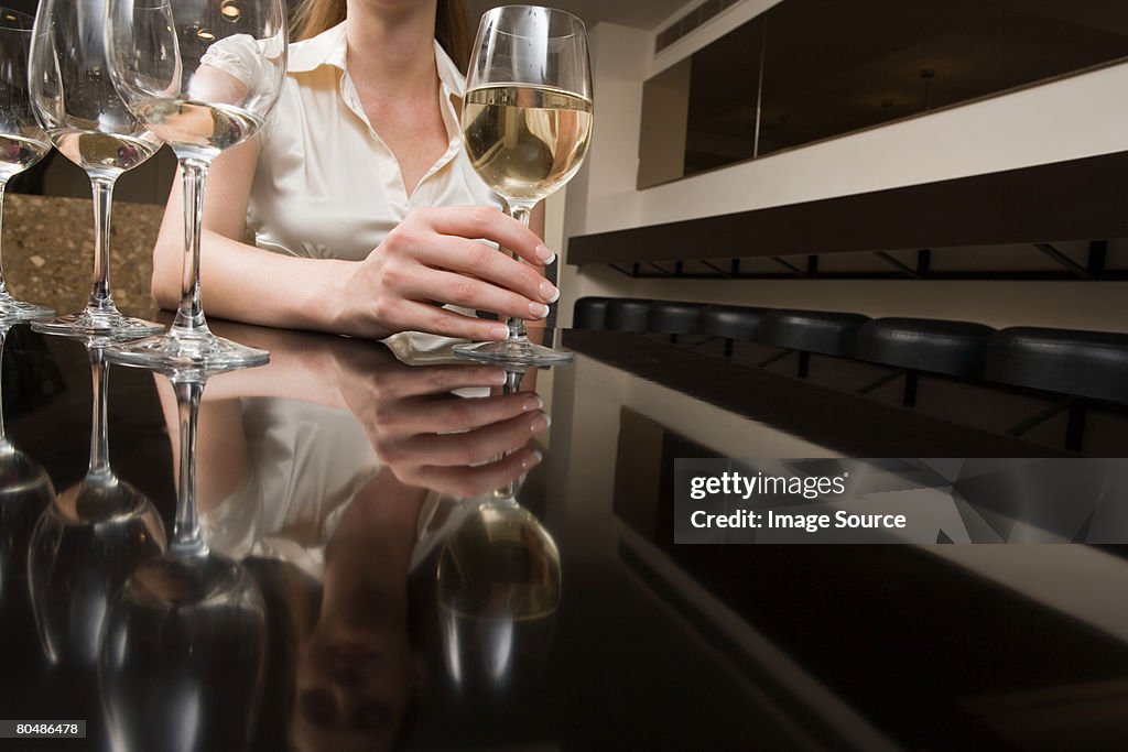 Woman drinking wine in a bar