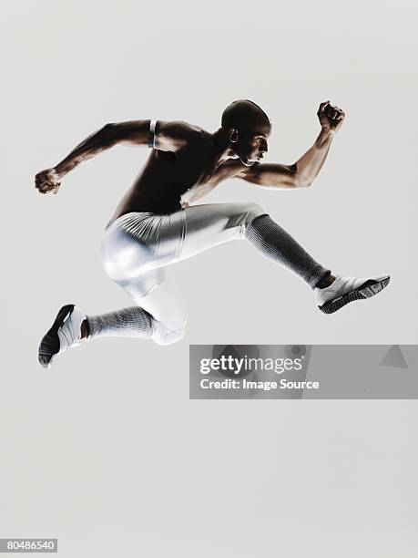 an athlete jumping - strong black man stock pictures, royalty-free photos & images