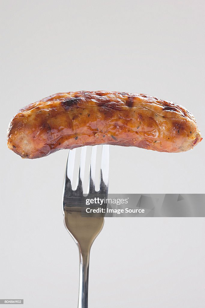 A sausage on a fork