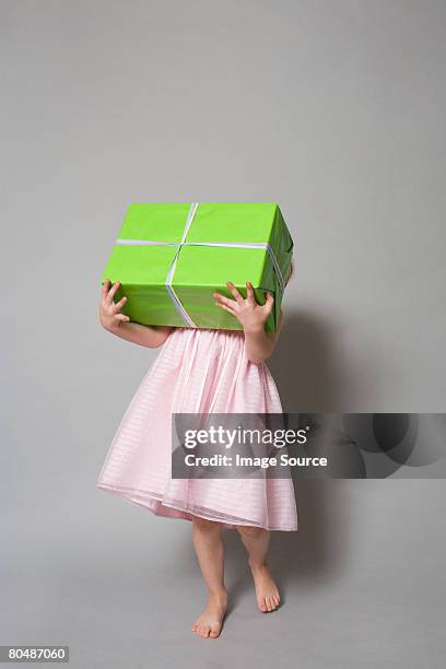 girl with a large present - funny gifts stock-fotos und bilder