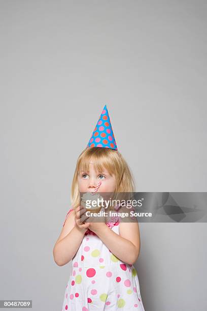 girl eating a cupcake - cupcakes girls stock-fotos und bilder