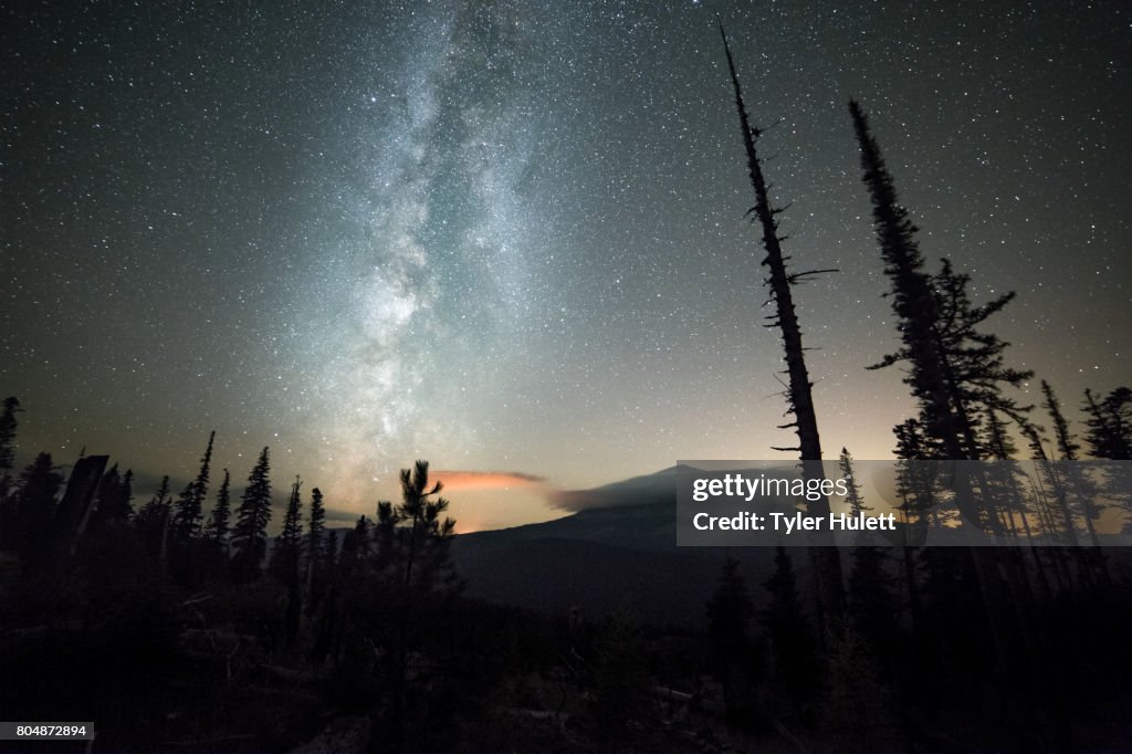 Milky way over a shrouded Mt. Hood and night sky with stars